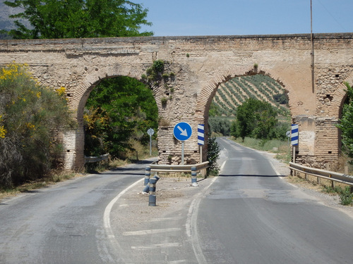 A newer road is built under an ancient Roman Aqueduct near Obeilar, Spain.